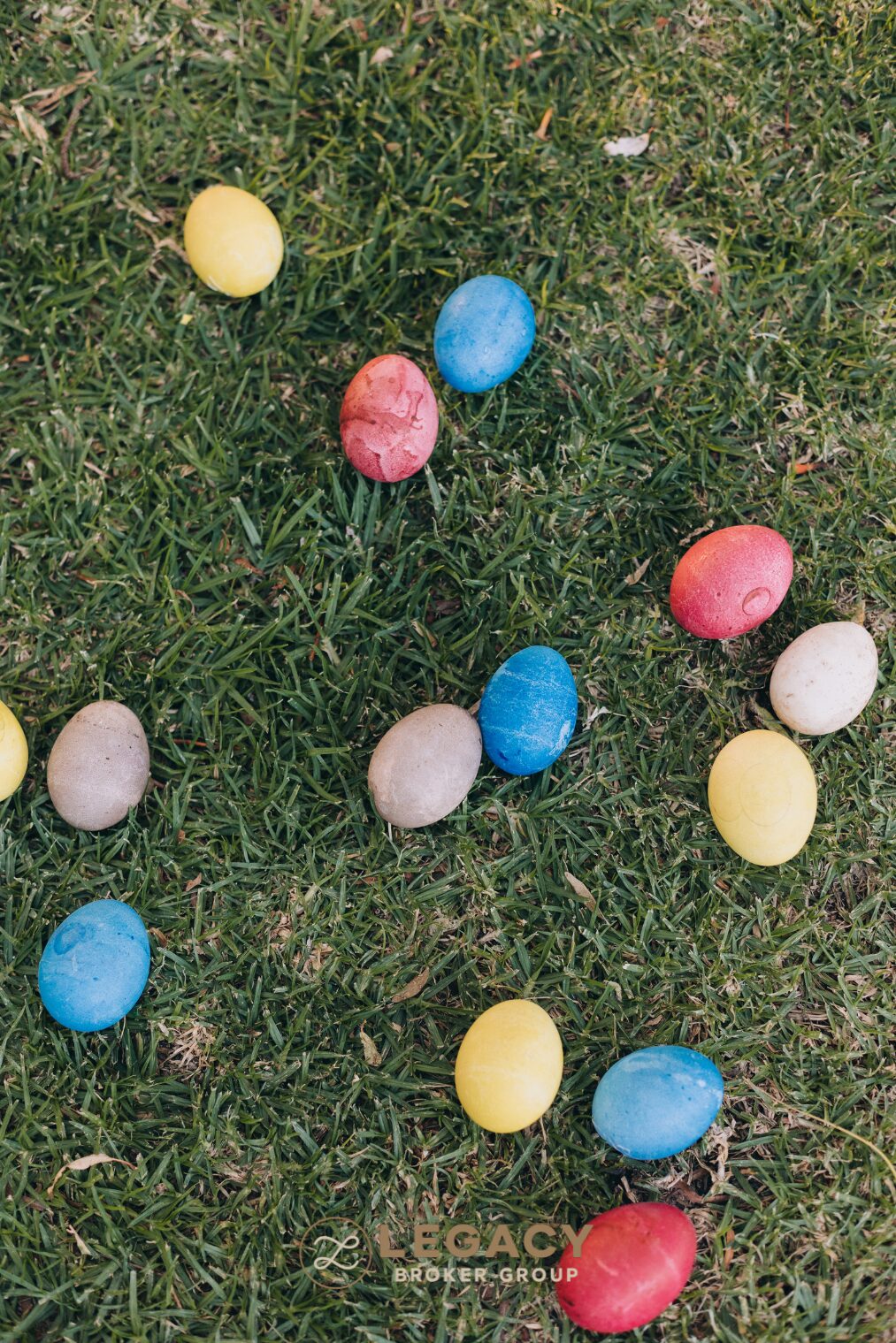 Dyed Easter eggs scattered in green grass, ready for an Easter egg hunt in Texas.