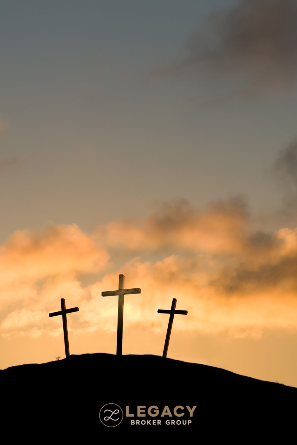 Three wooden crosses on a hill at sunset, marking Good Friday in the Christian tradition observed across Texas.