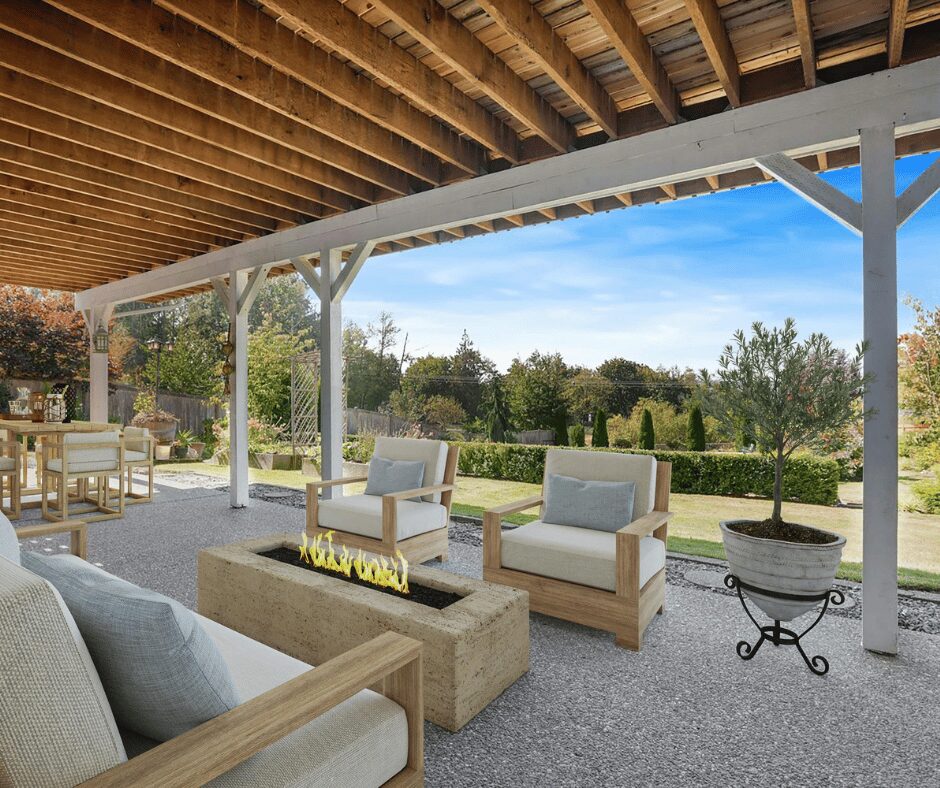 Stylish outdoor seating area with cushioned chairs, modern fire pit, and garden views under a wooden pergola.