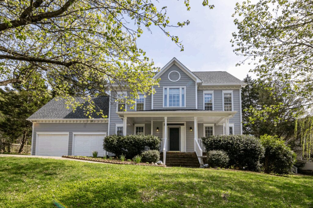Traditional Texas single-family home with front porch and mature trees, ideal for first-time homebuyers in a quiet residential neighborhood.